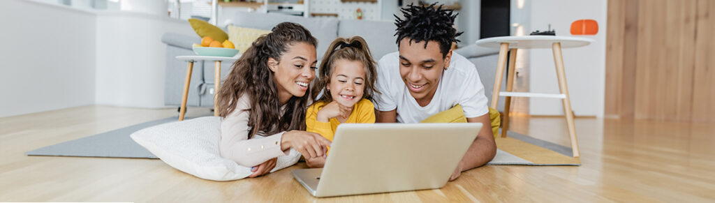 Happy family uses a laptop with fast internet.